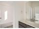 Bright bathroom with vanity, sink, and bathtub at 14586 W 91St Ave # A, Arvada, CO 80005