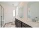 Bathroom with double vanity, quartz countertop, and shower at 14586 W 91St Ave # A, Arvada, CO 80005