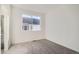 Bright bedroom with gray carpet and window at 14586 W 91St Ave # A, Arvada, CO 80005