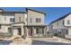 Modern two-story townhome with gray siding, private patio, and walkway at 14586 W 91St Ave # A, Arvada, CO 80005