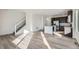 Open concept kitchen and living area with hardwood floors and island at 14586 W 91St Ave # A, Arvada, CO 80005