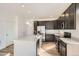 Modern kitchen with island, stainless steel appliances, and hardwood floors at 14586 W 91St Ave # A, Arvada, CO 80005