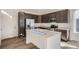 Modern kitchen with dark cabinets and quartz countertops at 14586 W 91St Ave # A, Arvada, CO 80005