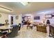 Spacious basement living area with tile flooring, a wood coffee table, and comfortable seating at 3724 S Poplar St, Denver, CO 80237