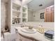Bathroom vanity with built in storage and white marble countertops at 3724 S Poplar St, Denver, CO 80237