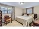 Calm bedroom featuring a large bed, matching wooden furnishings, two large windows and decorative curtains at 3724 S Poplar St, Denver, CO 80237