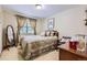 Bedroom with a patterned bed, matching curtains, and an accent chair at 3724 S Poplar St, Denver, CO 80237
