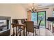 Bright breakfast nook adjacent to the kitchen with seating for four, sliding glass door and a leafy backyard view at 3724 S Poplar St, Denver, CO 80237