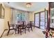 Bright dining room featuring a classic wooden table set, large window with natural light, and elegant drapery at 3724 S Poplar St, Denver, CO 80237