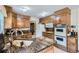 Well-equipped kitchen featuring dark granite countertops, ample wooden cabinetry, and classic appliances at 3724 S Poplar St, Denver, CO 80237