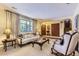 Elegant living room with plush seating, large windows, and stylish decor, creating a comfortable and sophisticated atmosphere at 3724 S Poplar St, Denver, CO 80237