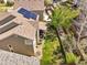 Aerial view of a home with solar panels, fenced backyard, and a cozy patio area, ideal for relaxation at 2602 E 145Th Ave, Thornton, CO 80602