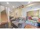 Spacious finished basement with a large couch, playroom area, and storage at 2602 E 145Th Ave, Thornton, CO 80602