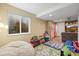 Basement playroom area with a window, storage, and sitting area at 2602 E 145Th Ave, Thornton, CO 80602