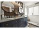 Modern bathroom with a double sink vanity, stylish wood accent wall, and a glass-enclosed shower at 2602 E 145Th Ave, Thornton, CO 80602