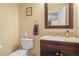 Bathroom with a toilet, sink, vanity, granite counter, and decor at 2602 E 145Th Ave, Thornton, CO 80602
