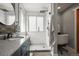 Well-lit bathroom featuring a sleek vanity with a stone countertop and a walk-in shower at 2602 E 145Th Ave, Thornton, CO 80602