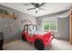 Cozy bedroom with a unique jeep-themed bed and a window with natural light at 2602 E 145Th Ave, Thornton, CO 80602