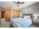 Bedroom features a ceiling fan, soft carpet, and a queen size bed at 2602 E 145Th Ave, Thornton, CO 80602