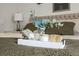 Close-up of a decorative tray with candle and greenery displayed on a well-made king size bed at 2602 E 145Th Ave, Thornton, CO 80602