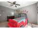 Cozy bedroom with a unique jeep-themed bed and neutral gray walls at 2602 E 145Th Ave, Thornton, CO 80602
