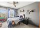 bedroom with blue accents, a football-themed bed, and ample natural light from the window at 2602 E 145Th Ave, Thornton, CO 80602