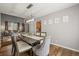 Open dining room with hardwood floors, modern chandelier, and decor art pieces at 2602 E 145Th Ave, Thornton, CO 80602