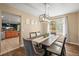 Sunlit dining room features modern lighting, a neutral color palette, and wood flooring at 2602 E 145Th Ave, Thornton, CO 80602