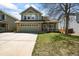 Charming two-story home with a manicured lawn, stone accents, and an attached two car garage at 2602 E 145Th Ave, Thornton, CO 80602