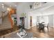 Open floor plan featuring a staircase and view into the dining room and kitchen at 2602 E 145Th Ave, Thornton, CO 80602