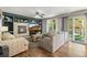 Inviting living room featuring a fireplace, built-in shelves, comfortable seating, and outdoor access at 2602 E 145Th Ave, Thornton, CO 80602