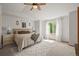 Bright main bedroom featuring a ceiling fan, cozy decor, and a sunlit window at 2602 E 145Th Ave, Thornton, CO 80602