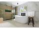Luxurious bathroom featuring a glass-enclosed shower, soaking tub, and modern fixtures, creating a spa-like experience at 4505 S Yosemite St # 362, Denver, CO 80237