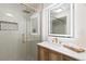 Modern bathroom featuring subway tile, glass enclosed shower, and a backlit mirror at 4505 S Yosemite St # 362, Denver, CO 80237
