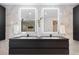 Modern bathroom with a sleek vanity, dual sinks, and illuminated mirrors providing ample lighting at 4505 S Yosemite St # 362, Denver, CO 80237