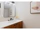 Bathroom featuring white countertop, modern vanity with decorative art, and a sleek mirror at 4505 S Yosemite St # 362, Denver, CO 80237