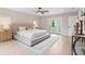 Bright bedroom with hardwood floors, a ceiling fan and a comfortable bed with soft neutral accents at 4505 S Yosemite St # 362, Denver, CO 80237