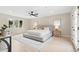 Bright bedroom with hardwood floors, a large window, ceiling fan and a comfortable bed with soft neutral accents at 4505 S Yosemite St # 362, Denver, CO 80237