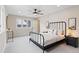 Bright bedroom with a black iron bed frame, neutral walls, and soft grey carpet at 4505 S Yosemite St # 362, Denver, CO 80237
