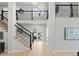 Beautiful two-story foyer with hardwood floors, modern staircase, and access to an outdoor patio at 4505 S Yosemite St # 362, Denver, CO 80237