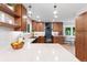 Well lit kitchen showcasing stone countertops, wooden cabinetry and modern pendants at 4505 S Yosemite St # 362, Denver, CO 80237
