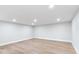 Bright, empty room with light hardwood floors and recessed lighting, ready for personalization at 4505 S Yosemite St # 362, Denver, CO 80237