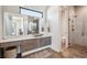 A modern bathroom features double sinks, a large mirror, and a glass-enclosed shower with elegant fixtures at 14545 Lipan St, Westminster, CO 80023