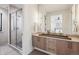 Modern bathroom features a glass shower, double vanity, and elegant fixtures, exuding spa-like luxury at 14545 Lipan St, Westminster, CO 80023