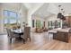 Open dining area with large windows providing natural light, flowing into the living room and kitchen space at 14545 Lipan St, Westminster, CO 80023