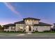 Elegant home exterior showcasing stone accents, a dark roof, a balcony, and lush landscaping at 14545 Lipan St, Westminster, CO 80023