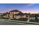Stunning exterior view of a modern two-story home with a pool and landscaped front yard at dusk at 14545 Lipan St, Westminster, CO 80023