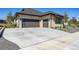 Modern home with stone accents, three-car garage, and spacious driveway at 14545 Lipan St, Westminster, CO 80023