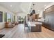 A modern kitchen with an island, sleek countertops, stainless steel appliances, and a seamless flow into the living area at 14545 Lipan St, Westminster, CO 80023