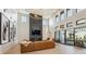 Spacious living room boasts a fireplace, soaring ceilings, modern lighting, and large windows for abundant natural light at 14545 Lipan St, Westminster, CO 80023
